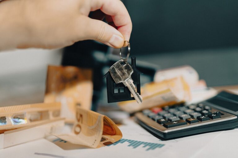 House key, calculator, and documents illustrating financial decisions Omaha sellers should review