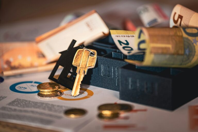 House model, mortgage documents, coins, and keys representing a comparison of home loan options