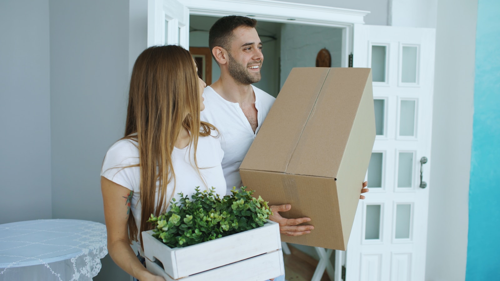 First-time home buyers standing together outside their new home