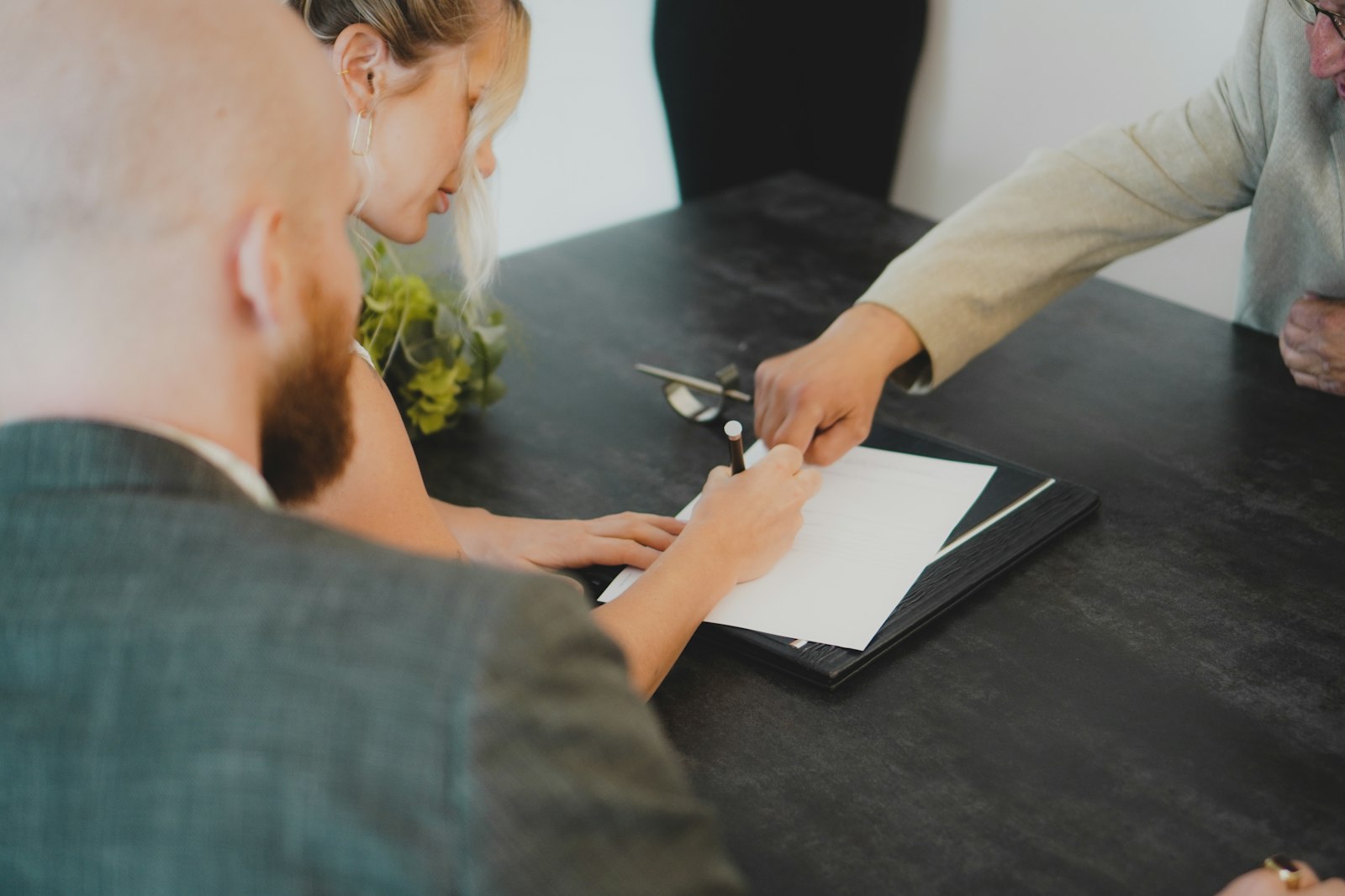 Home buyers reviewing mortgage closing documents together
