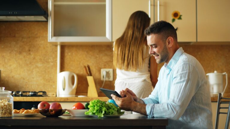 Couple reviewing a home-buying budget together at a kitchen table