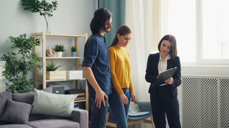 Prospective home buyers touring a house with a real estate professional