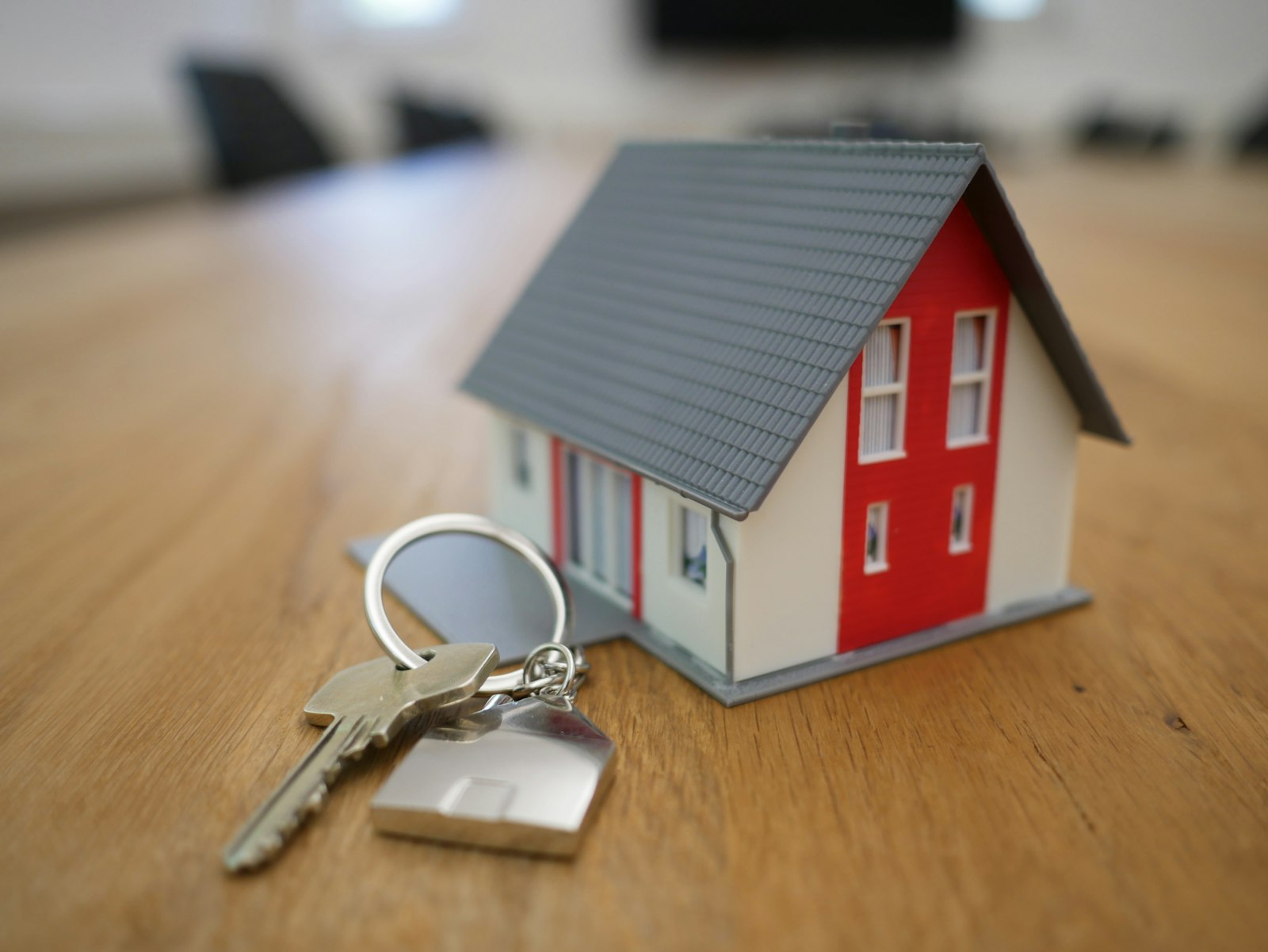 House keys, a model home, and documents representing down payment planning