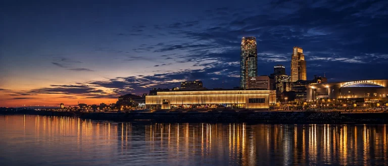 Downtown Omaha skyline at twilight reflected across the Missouri River