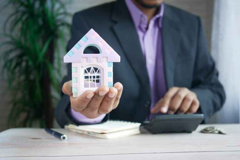 House model illustrating costs of owning a home beyond the mortgage