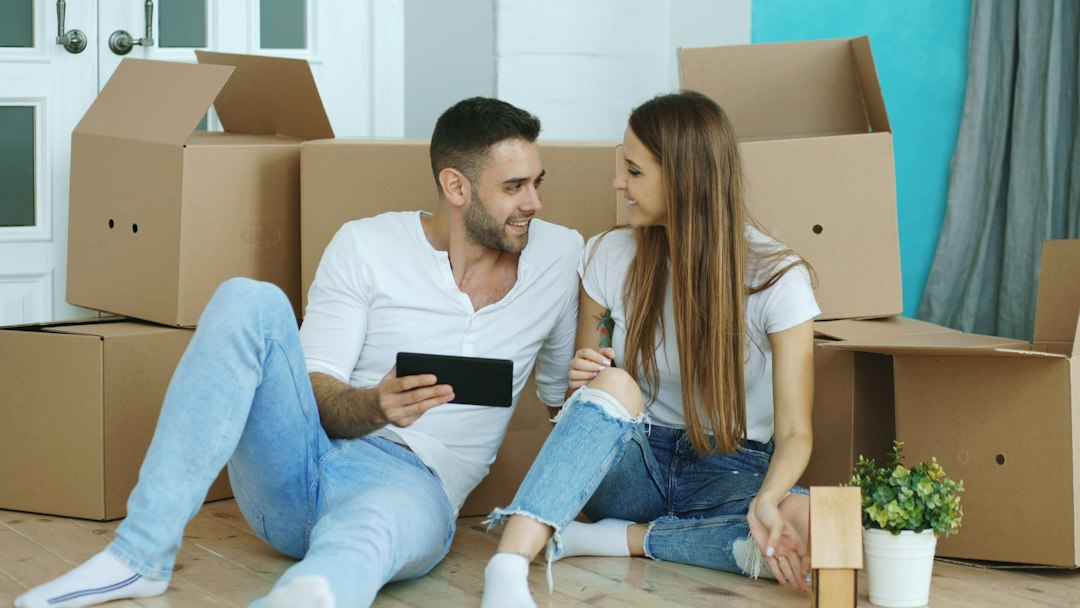 People using a tablet after a move, illustrating relocation planning