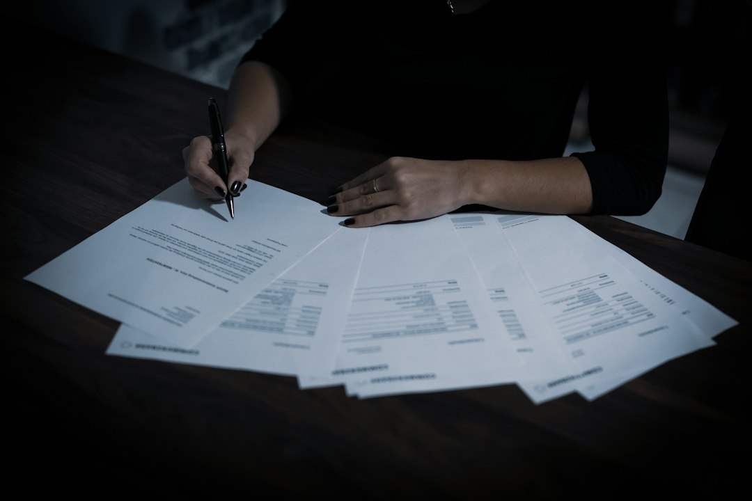 Home seller signing property disclosure paperwork
