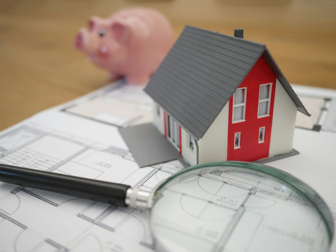 House model and paperwork illustrating a home sale during divorce