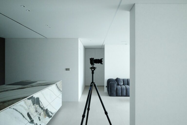 Camera on a tripod in a modern interior illustrating professional listing photography